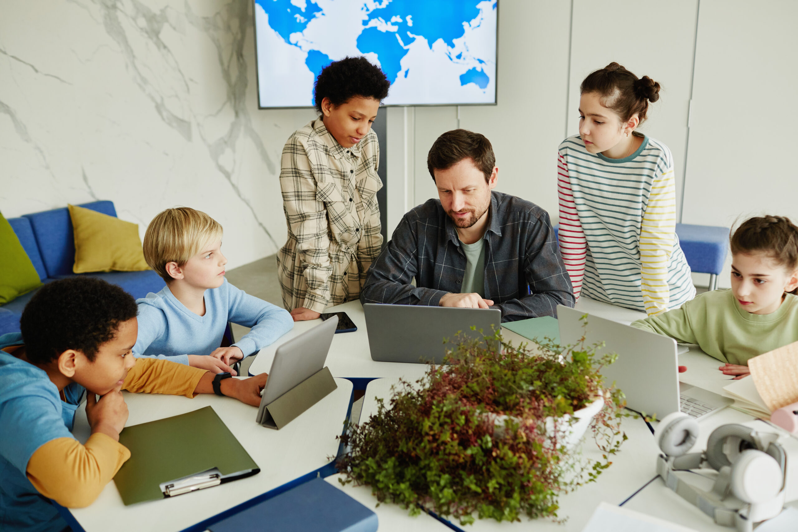 schoolkids with teacher in classroom
