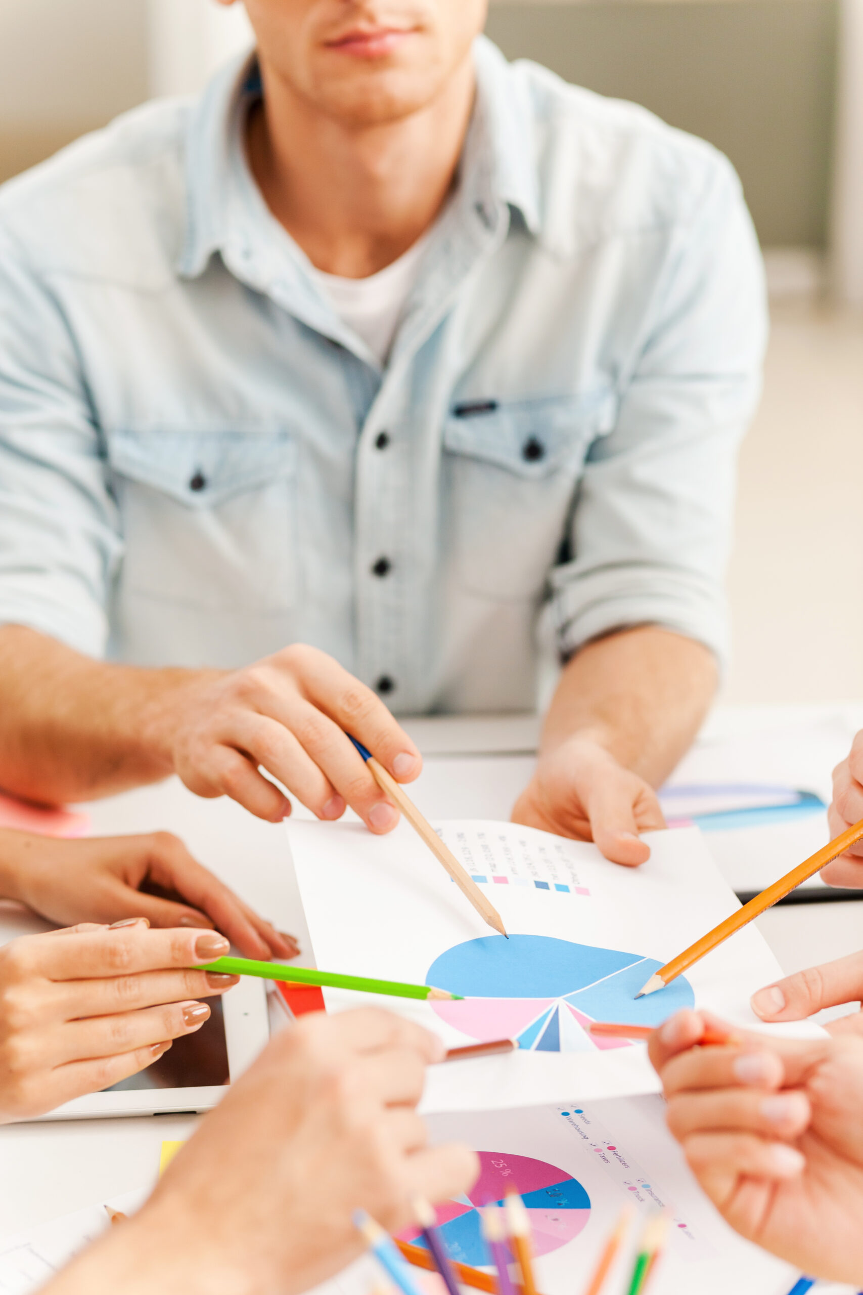 group discussion. close up of business people pointing diagram together while sitting at the table